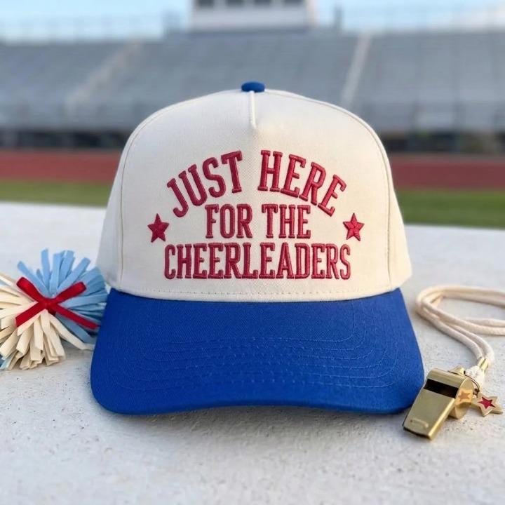 Two-tone royal blue and cream cheerleader supporter hat displayed at a stadium