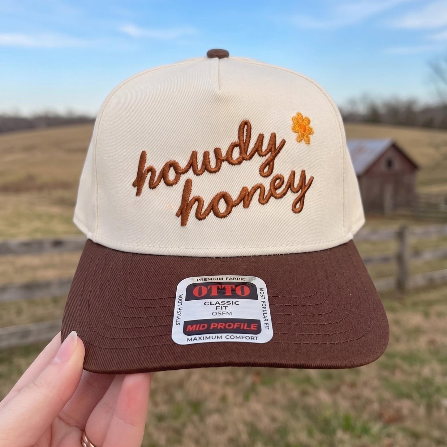 Howdy Honey embroidered trucker hat in cream and brown with decorative flower