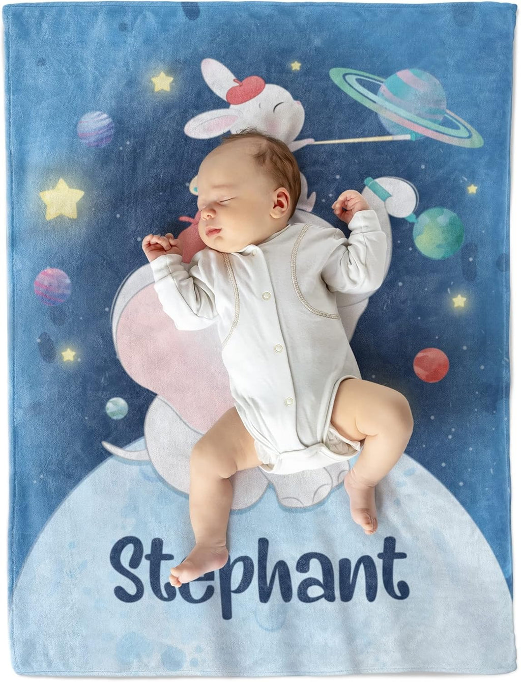 Baby lying on custom name blanket with elephant and bunny space design