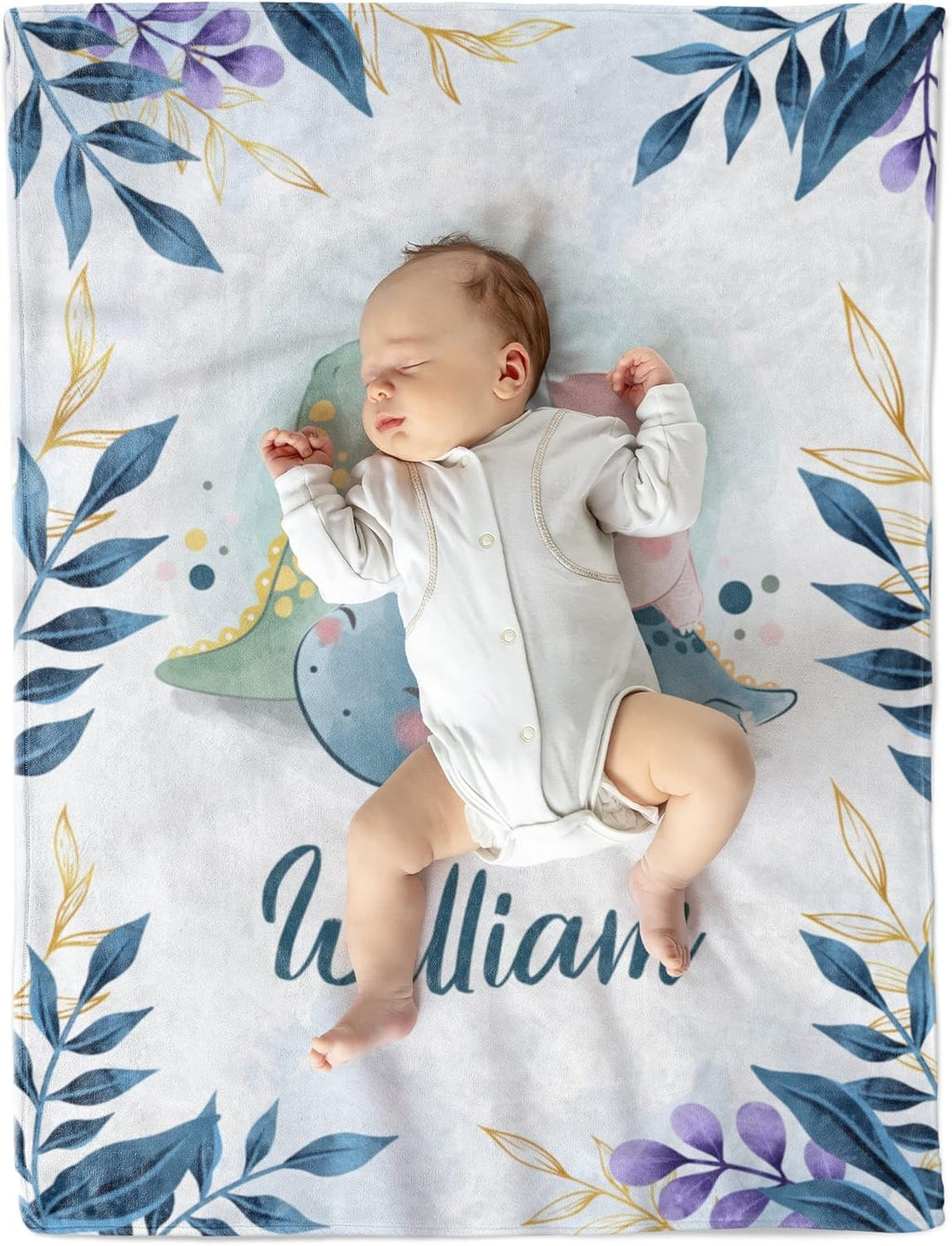 Baby lying on soft custom name blanket with dinosaur print