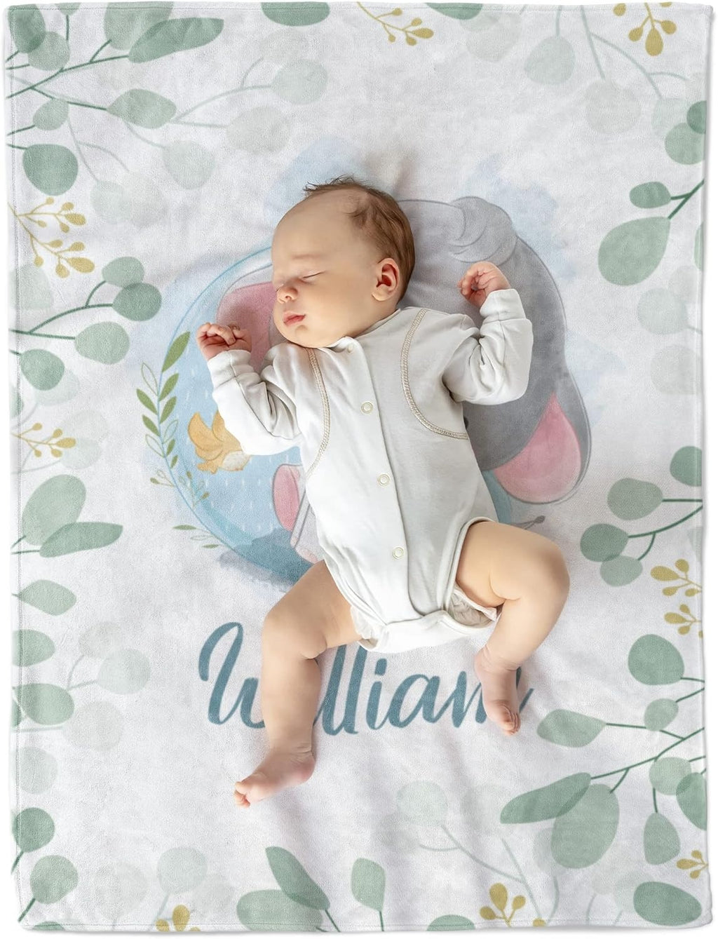 Baby lying on personalized blanket with elephant and green leaves