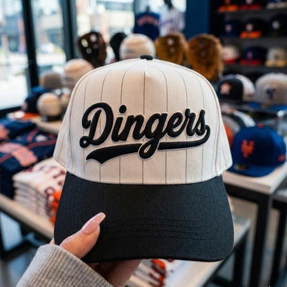 White pinstripe baseball hat with black brim and embroidered Dingers script