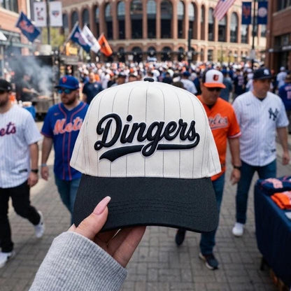 Embroidered Dingers pinstripe hat shown outside a baseball stadium