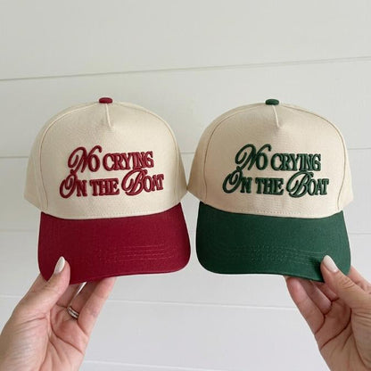 Two-tone trucker hats embroidered with No Crying on the Boat in burgundy and forest green