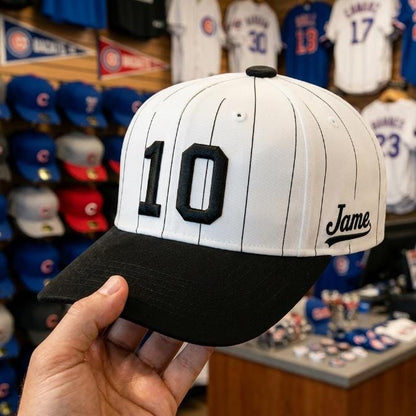 White pinstripe baseball hat with black brim and number 10 displayed in a baseball merchandise shop