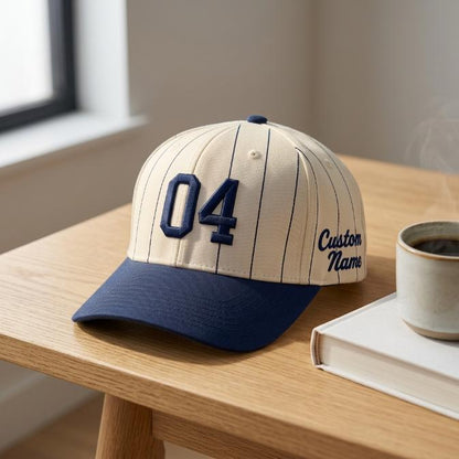 Personalized pinstripe baseball cap with 04 number and Custom Name displayed on a wooden desk