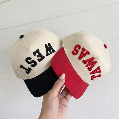 Two two-tone trucker hats with bold black and red embroidered lettering