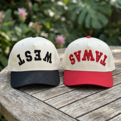 Black and red bill trucker hats displayed side by side outdoors