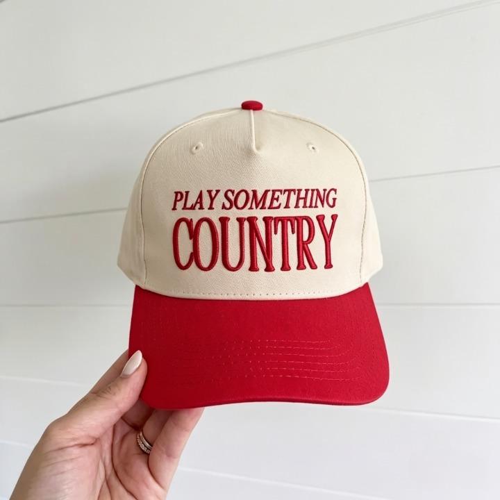 Cream and red two-tone trucker cap with Play Something Country embroidery