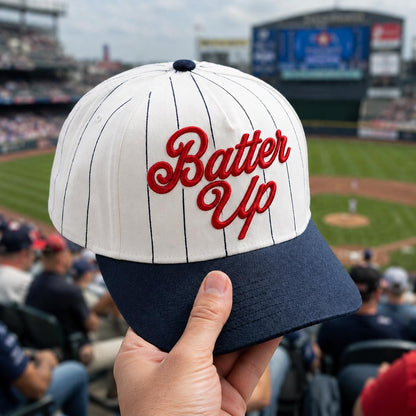 White pinstripe baseball cap with red Batter Up embroidery and navy bill