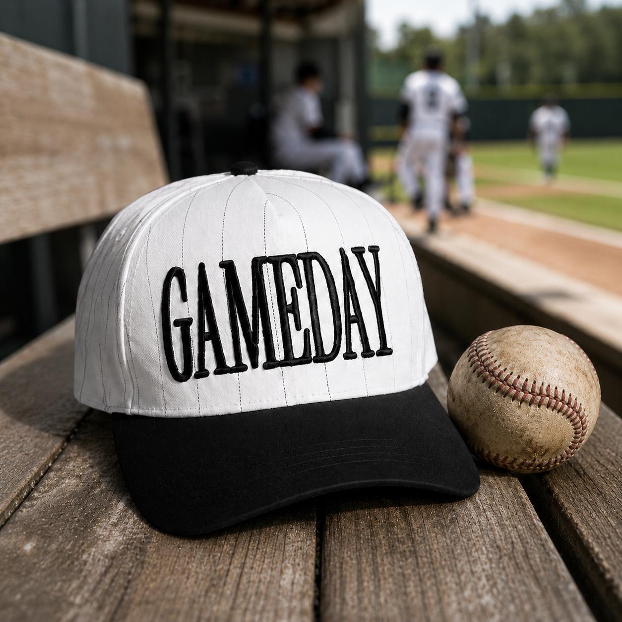 GAME DAY embroidered pinstripe hat styled beside a baseball at a ballpark