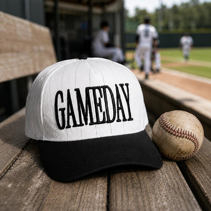 GAME DAY embroidered pinstripe hat styled beside a baseball at a ballpark