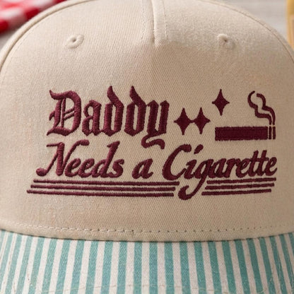 Close-up of Daddy Needs a Cigarette embroidery with stars and cigarette graphic