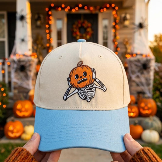 Two-tone cream and light blue hat with embroidered pumpkin skeleton design