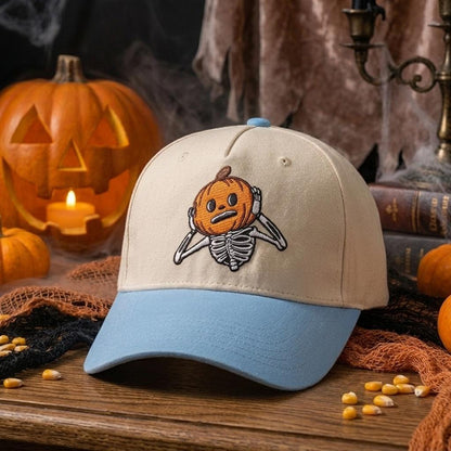 Pumpkin skeleton hat displayed on a wooden table with Halloween decor
