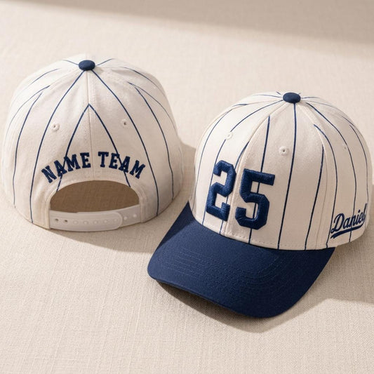 White pinstripe baseball hat with embroidered number 25 and navy brim