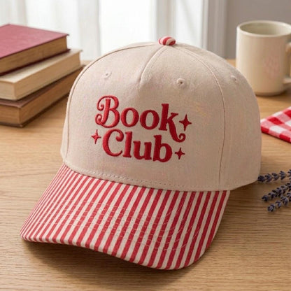 Angled view of Book Club embroidered hat with red striped brim