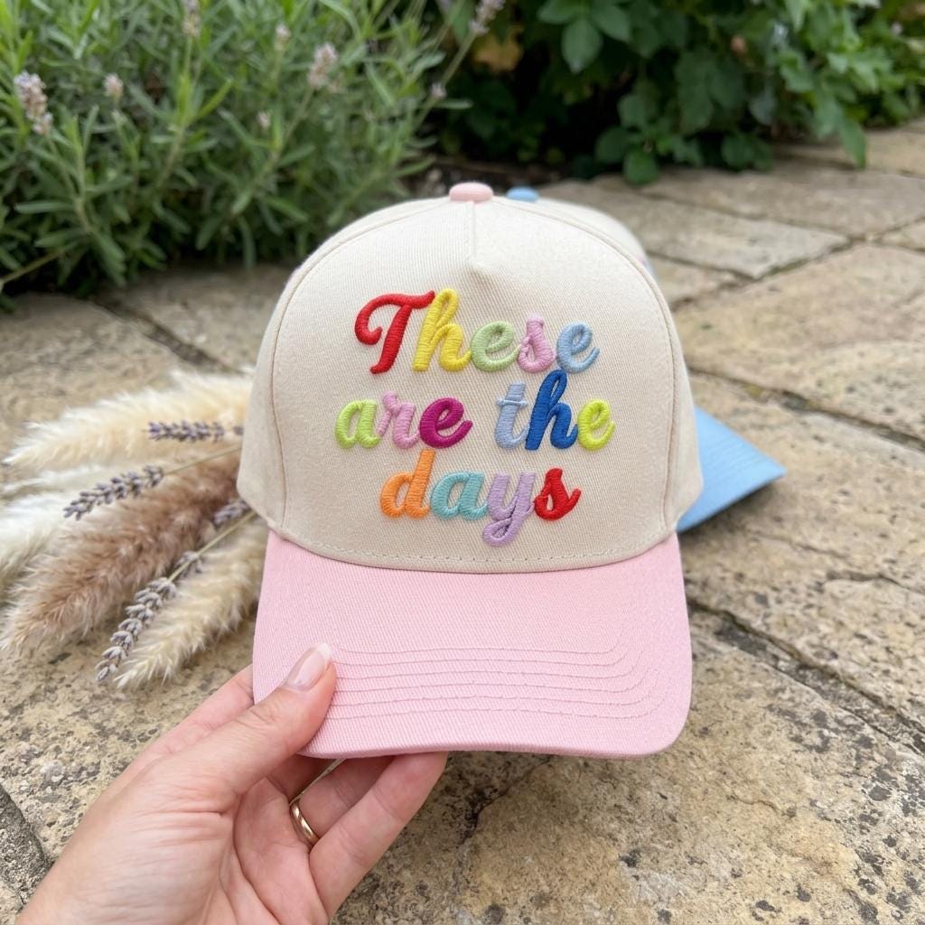 Pink brim These are the days embroidered hat held outdoors