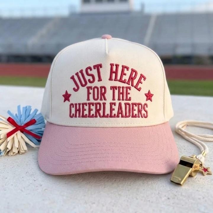Two-tone pink and cream hat featuring Just Here for the Cheerleaders lettering