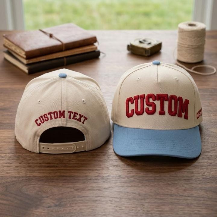 Front and back views of a custom text snapback hat on a wooden table