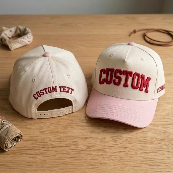 Personalized snapback cap with pink contrast brim and custom lettering
