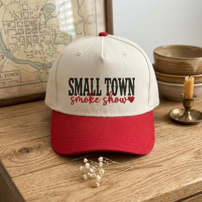 Small Town Smoke Show embroidered hat displayed on a wooden table