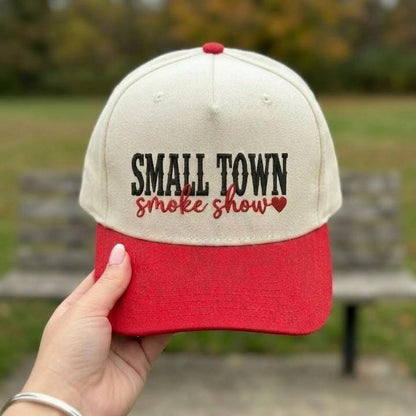 Front view of a cream and red embroidered Small Town Smoke Show hat with a heart detail