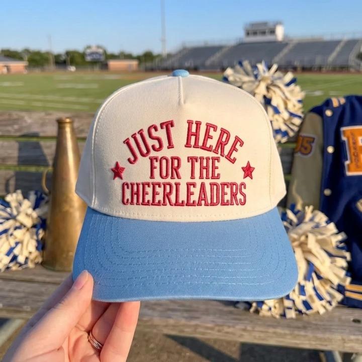 Two-tone light blue and cream hat embroidered with Just Here for the Cheerleaders and star accents