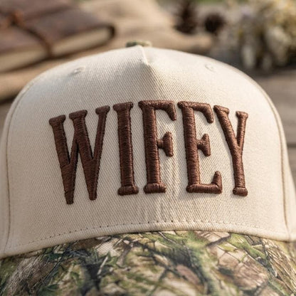 Detailed view of embroidered Wifey lettering on a two-tone trucker hat