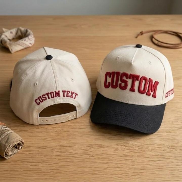 Light crown snapback hat with red custom lettering and black brim