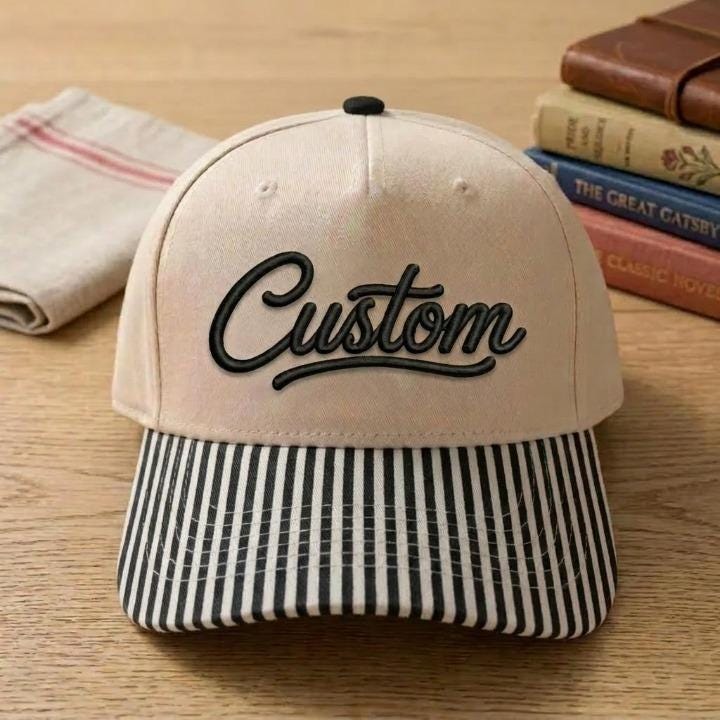 Cream embroidered hat with black-and-white striped bill