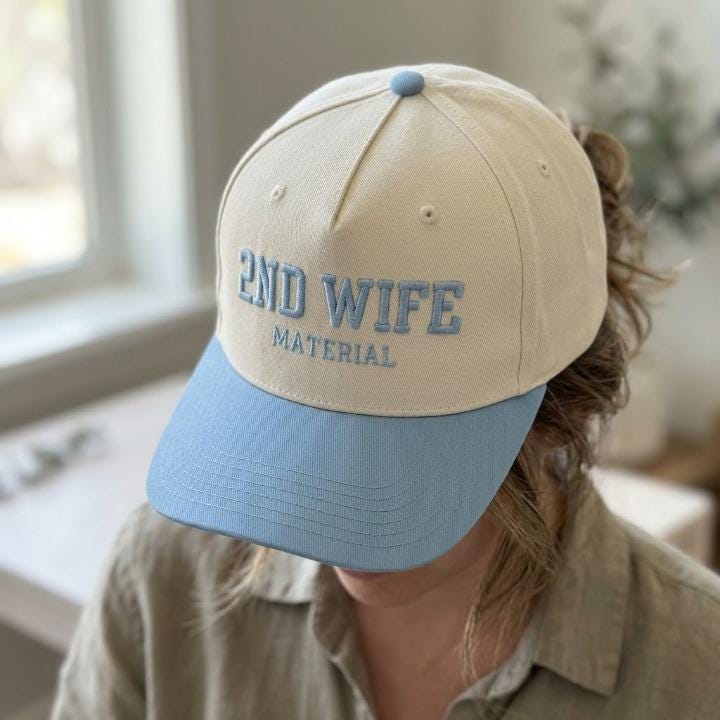 Side view of a person wearing the cream and blue 2ND WIFE MATERIAL hat