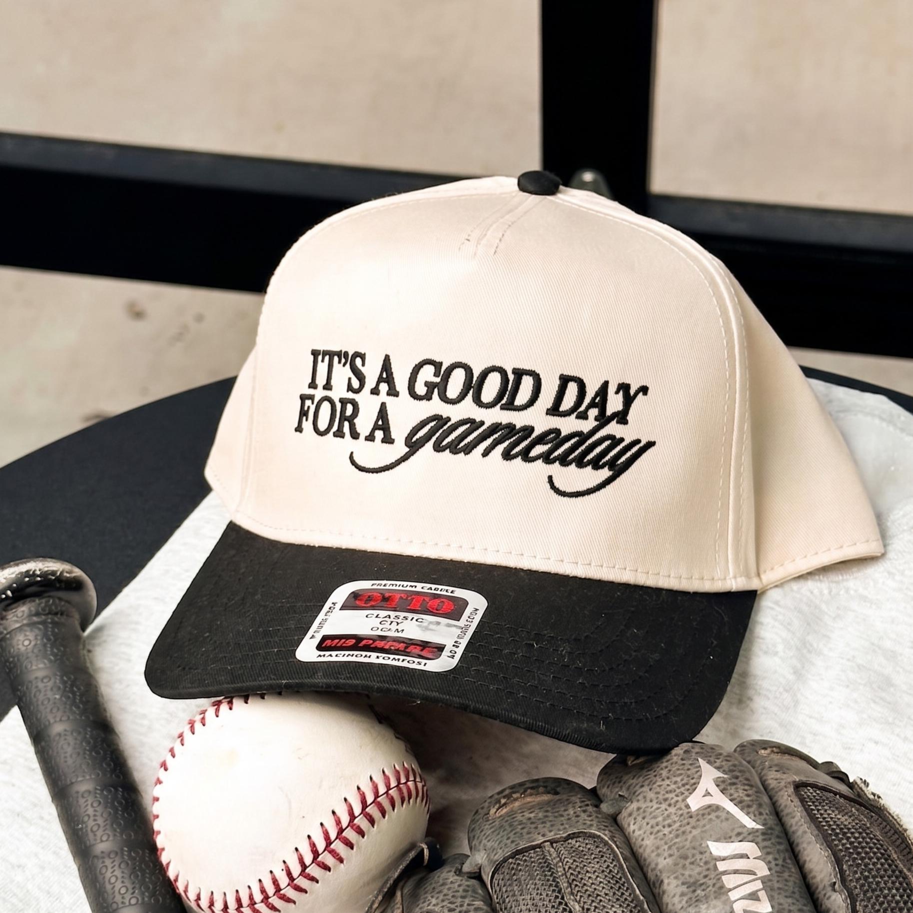 Baseball cap with 'It's A Good Day for a Gameday' embroidered in black, featuring a cream body and black brim, positioned