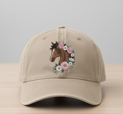 Embroidered beige baseball cap with horse and floral design on wooden table