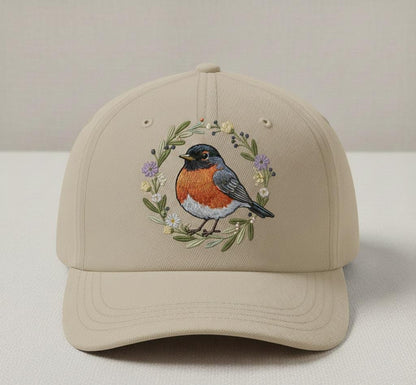 Beige canvas cap with embroidered bird and floral accents