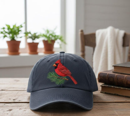 Embroidered cardinal bird dark blue cap with adjustable strap on wooden table