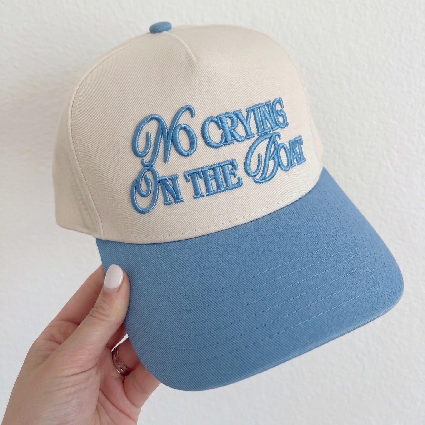 Two-tone blue and beige baseball cap with 'No Crying On The Boat' embroidered in blue